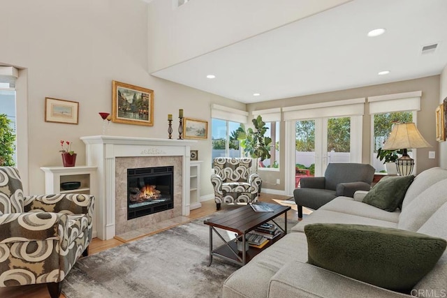 living room featuring visible vents, recessed lighting, a fireplace, and wood finished floors