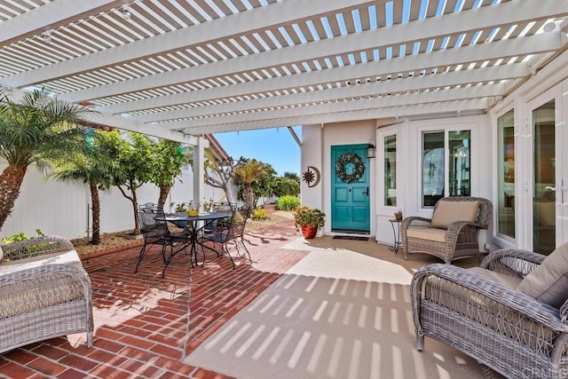 view of patio featuring outdoor dining space and fence