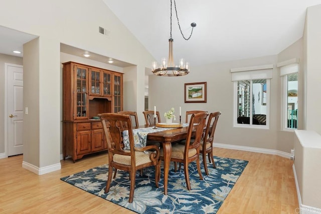 dining room featuring a notable chandelier, light wood-style floors, visible vents, and baseboards