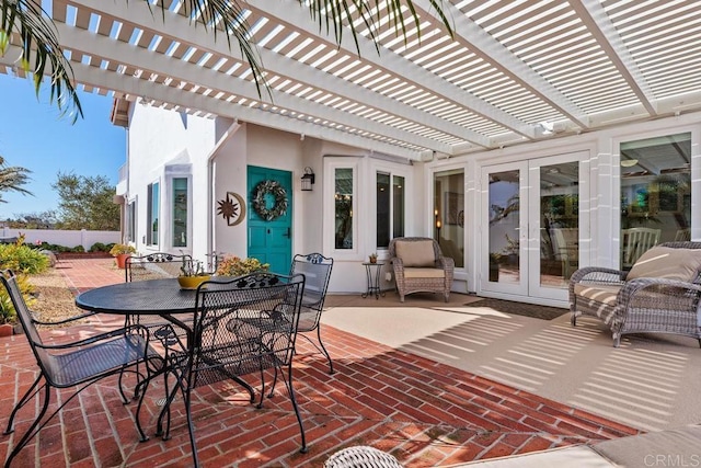 view of patio featuring french doors, a pergola, outdoor dining area, and fence