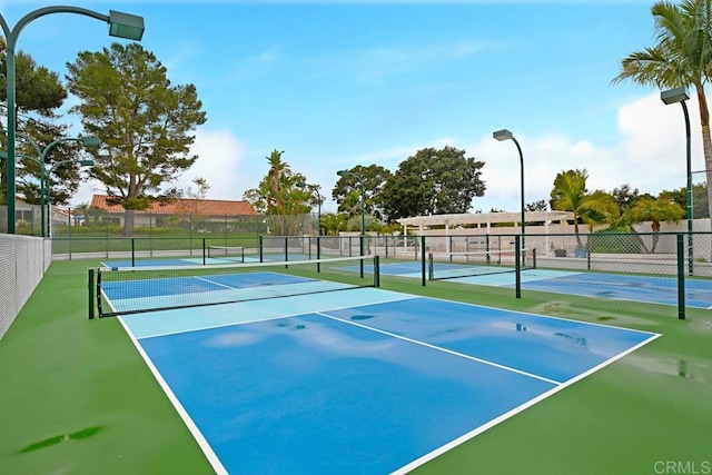 view of sport court with fence