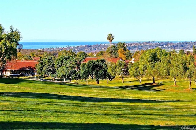 surrounding community featuring a lawn and a water view