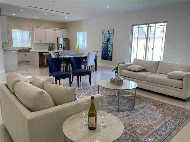 living room featuring plenty of natural light, recessed lighting, and baseboards