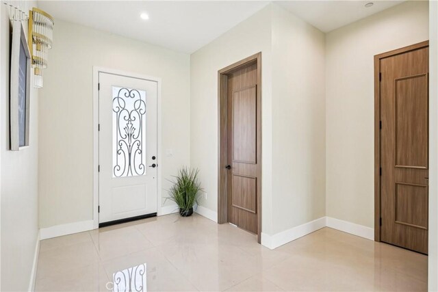 foyer featuring baseboards and recessed lighting