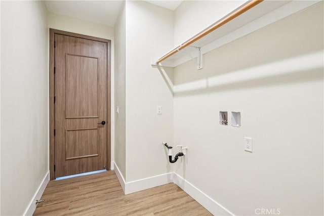 laundry area featuring laundry area, light wood finished floors, baseboards, and hookup for a washing machine