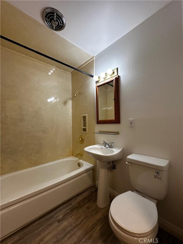 full bathroom with wood finished floors, baseboards, visible vents, shower / bath combination, and toilet