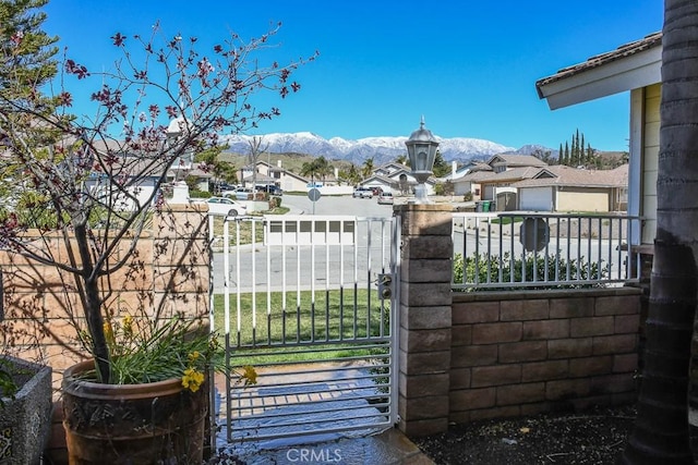 view of gate featuring fence and a mountain view