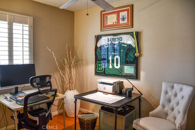 office with baseboards and a textured ceiling