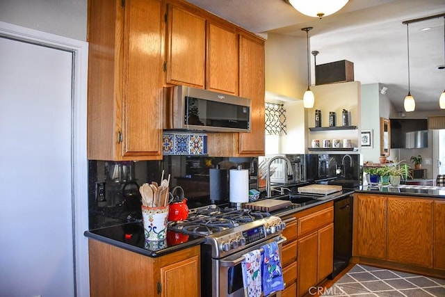 kitchen featuring brown cabinetry, appliances with stainless steel finishes, and a sink