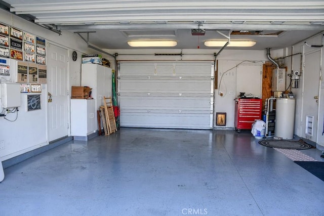 garage featuring gas water heater and a garage door opener