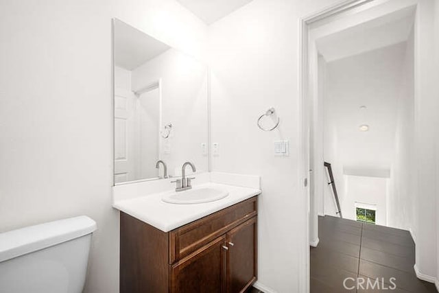 bathroom with toilet and vanity