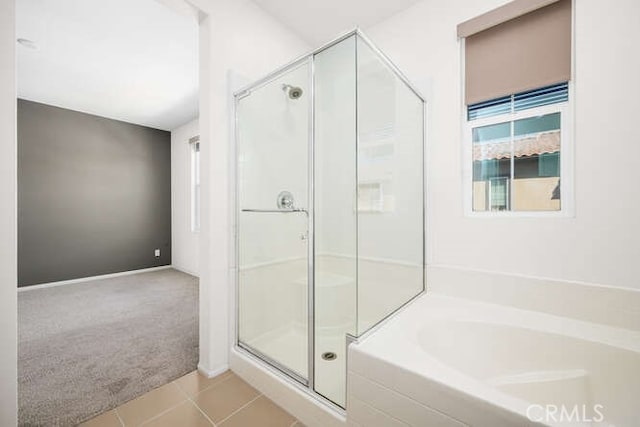 full bathroom featuring tile patterned floors, a stall shower, and a garden tub