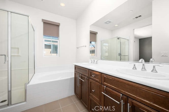 bathroom featuring a sink, a garden tub, a shower stall, and tile patterned floors