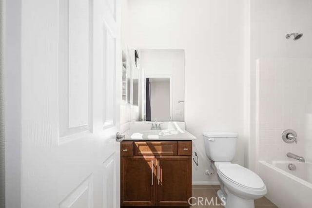 bathroom featuring washtub / shower combination, toilet, and vanity