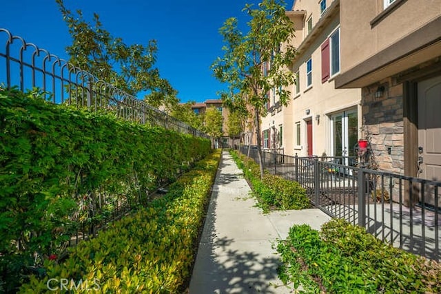 view of property's community featuring a residential view and fence