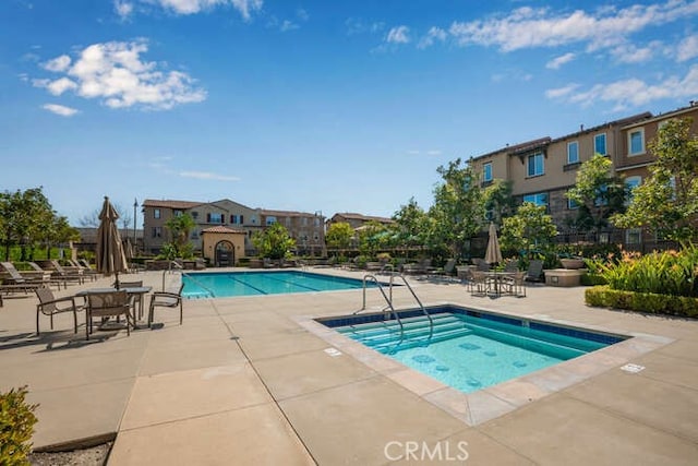 community pool featuring a patio and a community hot tub