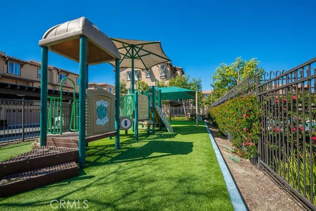 community playground with a yard and fence