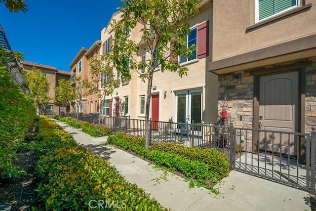 view of home's community with fence and a residential view