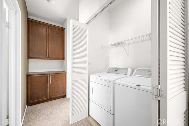 laundry area with washer and dryer, laundry area, and light colored carpet