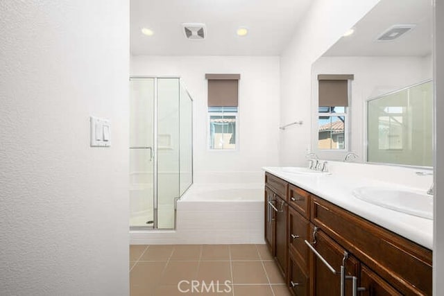 full bathroom with a sink, visible vents, a wealth of natural light, and a bath