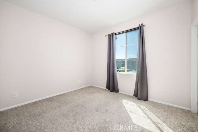 spare room with carpet flooring and baseboards