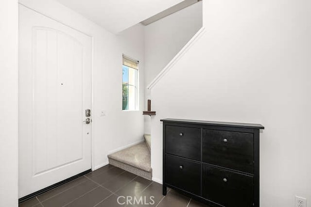 entrance foyer featuring dark tile patterned flooring