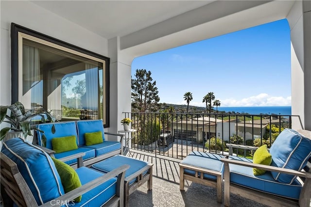 balcony featuring a water view and outdoor lounge area