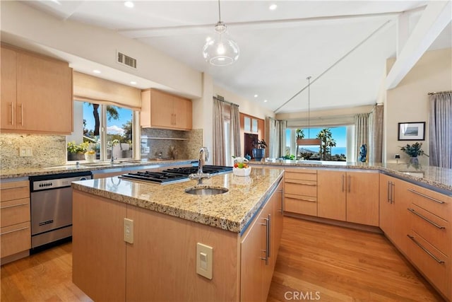 kitchen featuring visible vents, light brown cabinets, vaulted ceiling with beams, light stone countertops, and stainless steel appliances