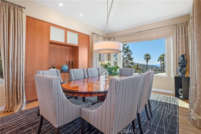 dining area featuring recessed lighting, lofted ceiling, and wood finished floors