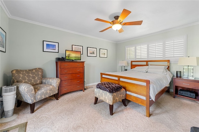 bedroom featuring light colored carpet, baseboards, a ceiling fan, and ornamental molding