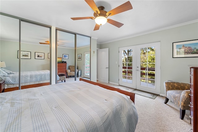 bedroom featuring access to exterior, crown molding, carpet, multiple closets, and french doors