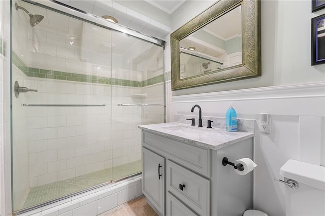 bathroom with toilet, a stall shower, and vanity