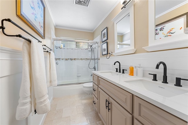 full bath with double vanity, ornamental molding, and a sink