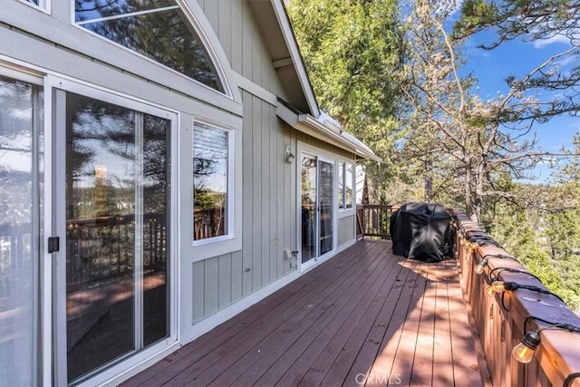 wooden terrace featuring grilling area