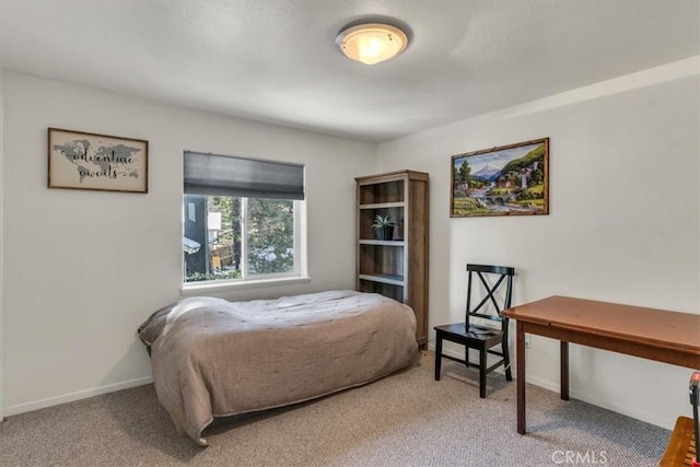 bedroom featuring baseboards and carpet flooring