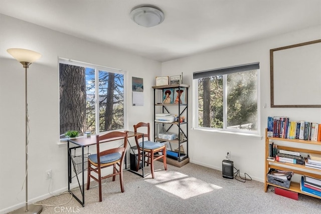 carpeted home office featuring baseboards