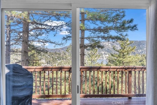 wooden terrace featuring a mountain view and grilling area