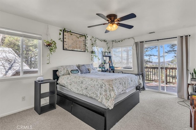 carpeted bedroom with visible vents, baseboards, ceiling fan, and access to outside