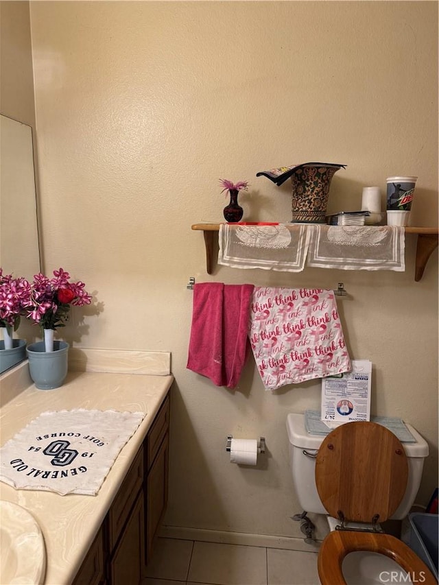 bathroom featuring tile patterned floors, toilet, and vanity