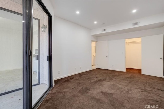 unfurnished room with visible vents, recessed lighting, baseboards, and carpet floors