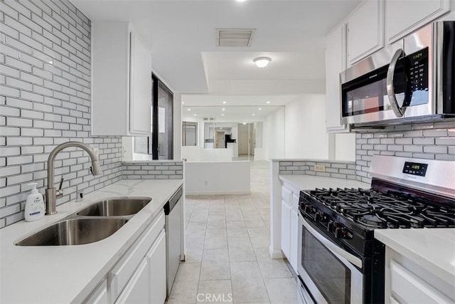 kitchen with visible vents, light countertops, light tile patterned floors, appliances with stainless steel finishes, and a sink