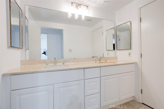 bathroom with tile patterned floors, double vanity, and a sink