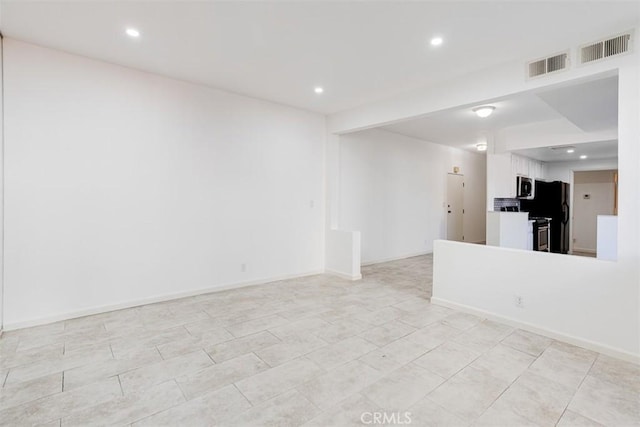 empty room with visible vents, recessed lighting, and baseboards