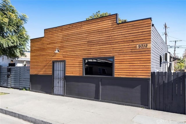 view of home's exterior with fence