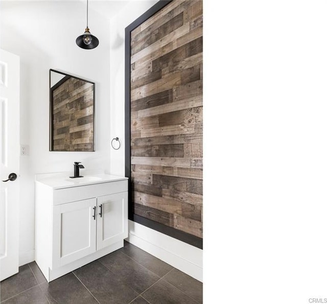 bathroom featuring tile patterned floors, wooden walls, and vanity