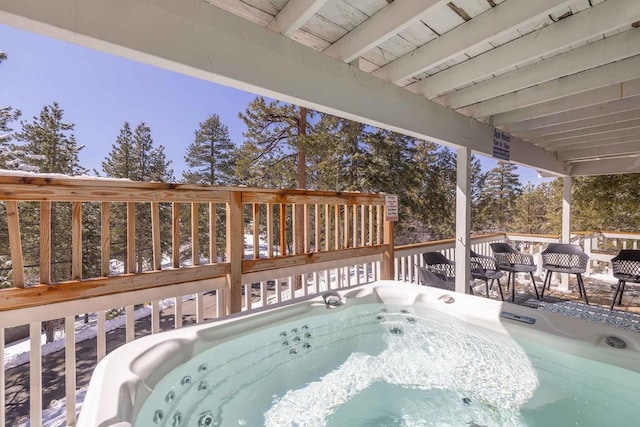 wooden deck with a hot tub