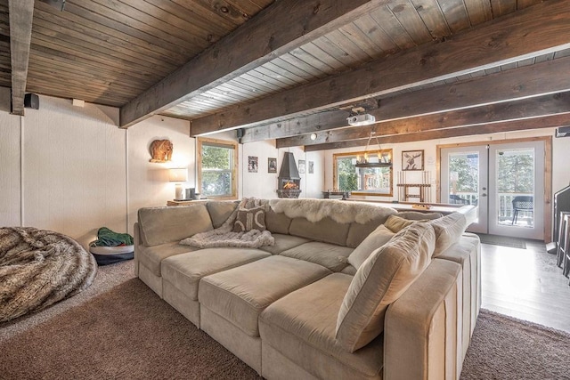 living room featuring french doors, beam ceiling, and wood ceiling