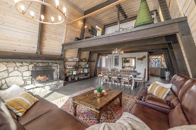 living area featuring an inviting chandelier, a fireplace, and wood walls