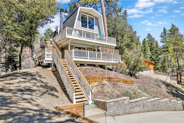 view of front of property featuring stairs and driveway