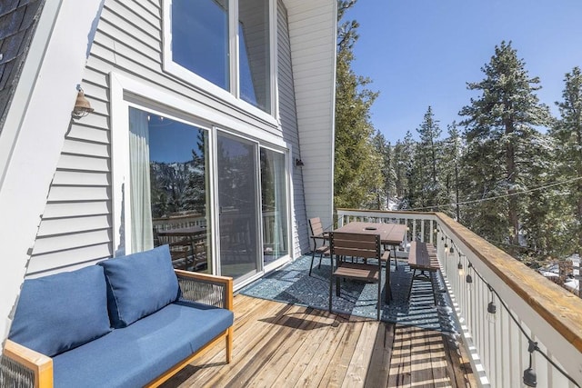 wooden terrace with outdoor dining area